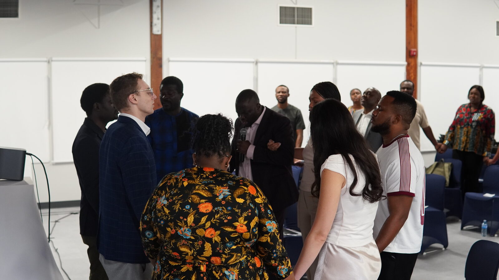 Attendees standing together in prayer at Church & State